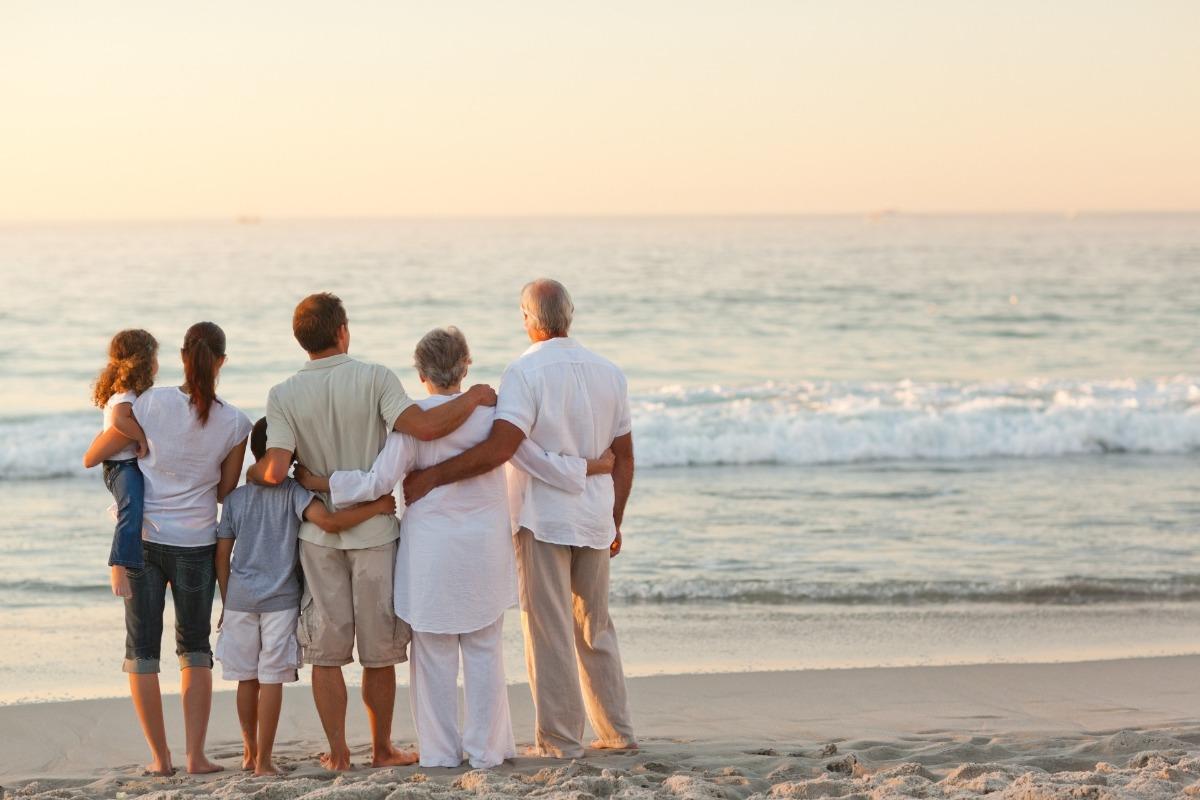 Family holding arms on the beach