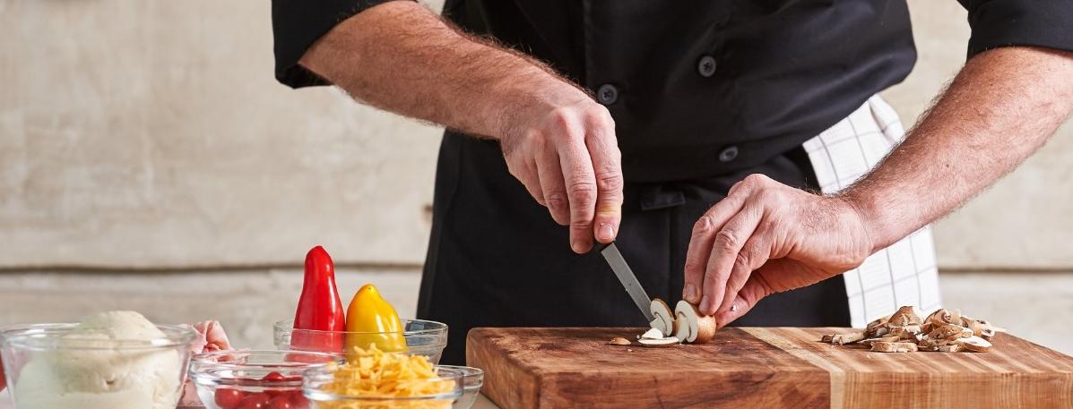 Chef cutting up mushrooms 